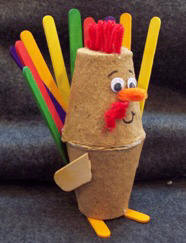 glue craft sticks to peat pots to make turkey decoration